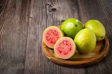 Fresh sliced ​​guavas on wooden table.