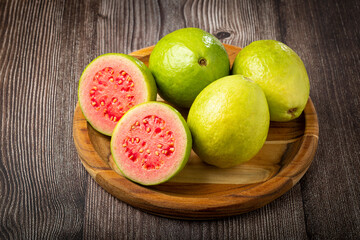 Fresh sliced ​​guavas on wooden table.
