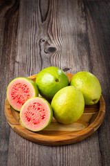 Fresh sliced ​​guavas on wooden table.