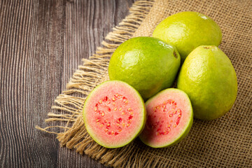 Fresh sliced ​​guavas on wooden table.
