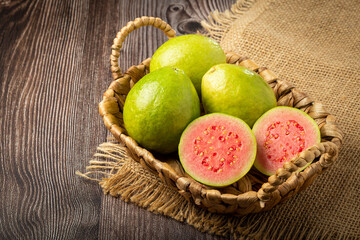Fresh sliced ​​guavas on wooden table.