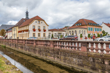 Fototapeta na wymiar Schwetzingen, Germany. Buildings on the bank of the canal in front of the castle
