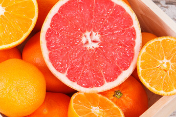 Fresh citrus in wooden box. Slimming, diet and healthy nutrition concept