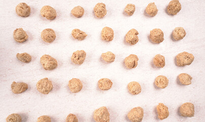 Raw soya chunks on dark background. Healthy, nutritious soybean meat, chunks isolated.Vegan food concept.