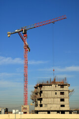 Tower cranes are working on the construction of a new house. Lifting crane.