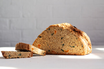 Fresh delicious homemade rye flour bread with grains and dried foods