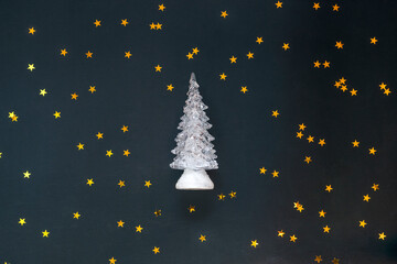 Christmas tree on black background around the stars. Greeting card. Merry Christmas and happy new year concept.