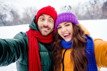 Photo of young excited girl guy happy positive smile make selfie fooling grimace have fun walk outdoors