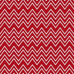 Christmas chevron pattern. Seamless Zig-zag pattern. Abstract background with white zig-zag stripes on a red background. Vector illustration