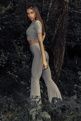 Picture of glamour esthetic sexy young pretty lady posing in the park outdoors. Outdoors fashion photo of brunette young lady with perfect body.
