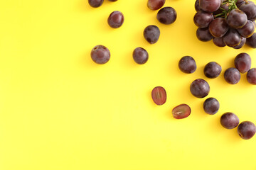 Red grapes isolated top view in yellow background