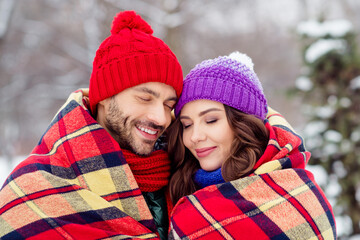 Photo of sweet dreamy girlfriend boyfriend dressed vests covering plaid duvet smiling closed eyes walking snow outdoors forest