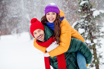 Photo of pretty adorable girlfriend boyfriend dressed vests smiling cuddling riding back walking...