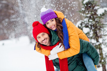Photo of sweet cute marriage couple wear windbreakers hugging smiling having fun walking snowy...