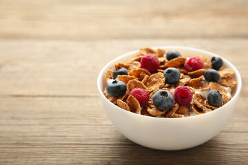 Breakfast with cereals and berry on grey background.