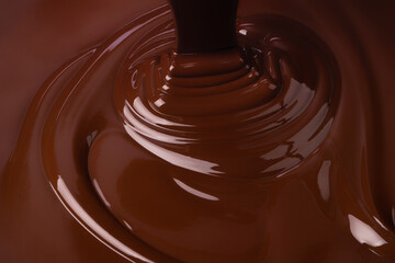 stream melt chocolate spreads in waves. hot cocoa background