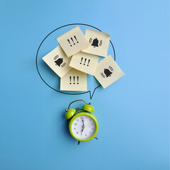 A green alarm clock and an image of exclamation marks and reminders. A symbol of many reminders to...