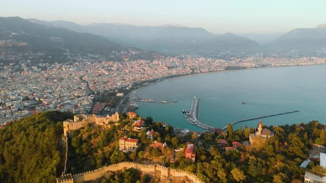 Aerial view resort city Alanya in southern coast of Turkey, Summer day. Travel and vacation. Kalesi Castle. Mountain. Ships and boats in the mediterranean