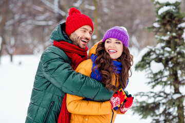 Photo of pretty shiny girlfriend boyfriend dressed vests smiling laughing hugging walking snow...