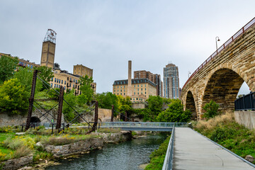 Mill Ruins Park and the Stone Arch Bridge in Minneapolis - obrazy, fototapety, plakaty