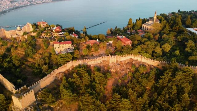 Aerial view resort city Alanya in southern coast of Turkey, Summer day. Travel and vacation. Kalesi Castle. Mountain. Ships and boats in the mediterranean