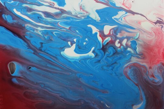 Abstract red-white-blue marble background. The lines and waves of acrylic paint create an interesting structure. Background for web design, fabric, design, laptop case.