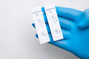 Positive and negative Covid-19 antigenic test for quick detection of disease in doctors hand in the...