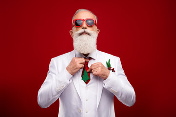 Photo of cool confident man dressed white christmas costume dark glasses preparing for party isolated red color background