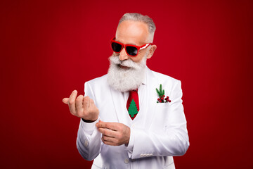 Photo of cheerful happy old man fix sleeves wear sunglass smile entertainer isolated on red color...