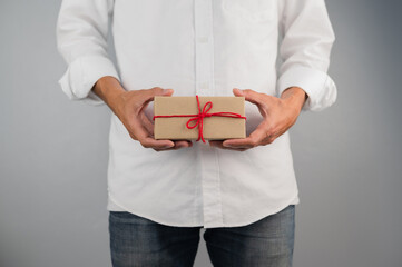 Fototapeta na wymiar Hand holding gift box, new year gift box, Christmas gift box ,copy space. Christmas, hew year, birthday concept.