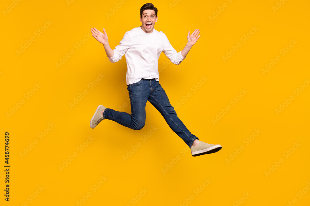 Canvas Prints Full size photo of funny brunet millennial guy jump wear shirt jeans sneakers isolated on yellow background