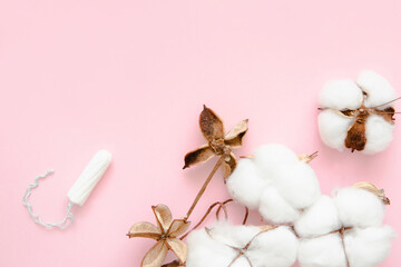 Natural cotton menstrual tampon, soft and delicate like cotton, on a pink background. Feminine hygiene items.