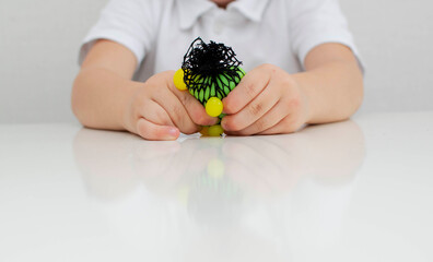 The child does an exercise with a relief ball for tactile sensations. Easy sensory classes for...