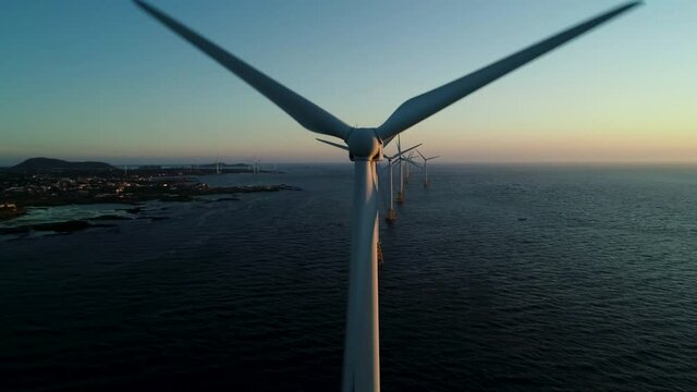 Beautiful sunset background the wind power generators on the sea, Offshore wind turbine in Jeju Island. South Korea. 제주 해안 풍력발전