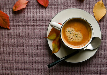 mug with coffee with yellow leaves. autumn. atmosphere.