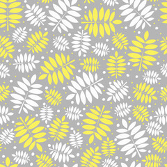 Naklejka na ściany i meble Seamless pattern of white and yellow leaves on a gray background. Elegant botanical print in flat style. Rowan leaves. Vector illustration.