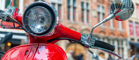Fototapeta premium Old fashioned red motorbike parked in city center