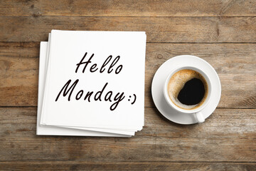 Start your week with good mood. Paper sheets with text Hello Monday and cup of coffee on wooden table, flat lay