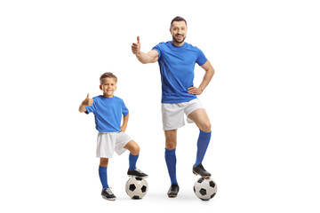 Man and boy with a soccer ball gesturing thumbs up
