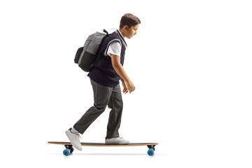 Full length profile shot of a schoolboy in a uniform riding a skateboard © Ljupco Smokovski