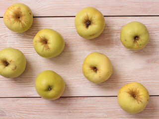 Big green apple on a kitchen scale on a wooden table