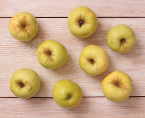 Big green apple on a kitchen scale on a wooden table
