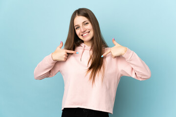 Young caucasian woman isolated on blue background proud and self-satisfied