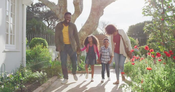Happy arfican american family walking outside and having fun