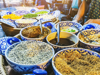Fototapeta premium Close up to Vegetables and fruits and various food ingredients for cooking delicious Thai Southern Spicy Rice Salad with Vegetable. Thai cuisine, Popular Thai southern food. Selective focus.