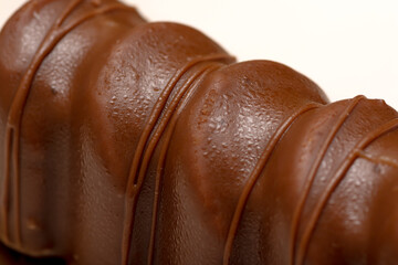 Closeup to chocolate and caramel cake white background