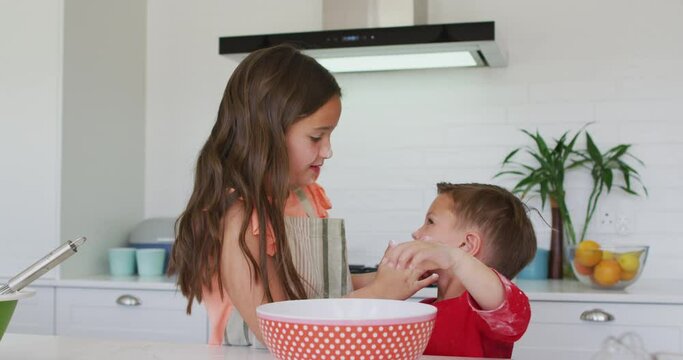 Happy Caucasian Sister And Brother Playing Together With Dough In Kitchen