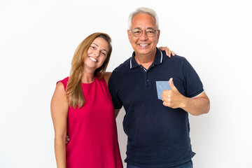 Middle age couple isolated on white background giving a thumbs up gesture