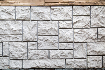 The background of the wall is made of artificial regular rectangular shape in white and gray. Backgrounds texture design.