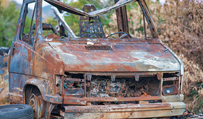 Car wreckage. Rusty car body, abandoned vehicle